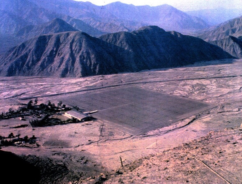 Aerial photograph of the Jicamarca Radio Observatory main antenna array in a desert valley near Lima, Peru.